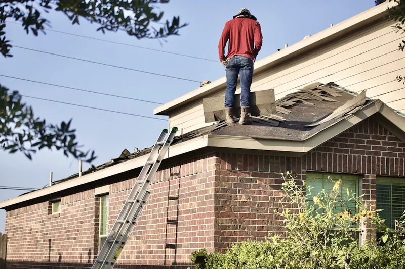 Professional roofer working on a residential roof in Cherry Hill Mall